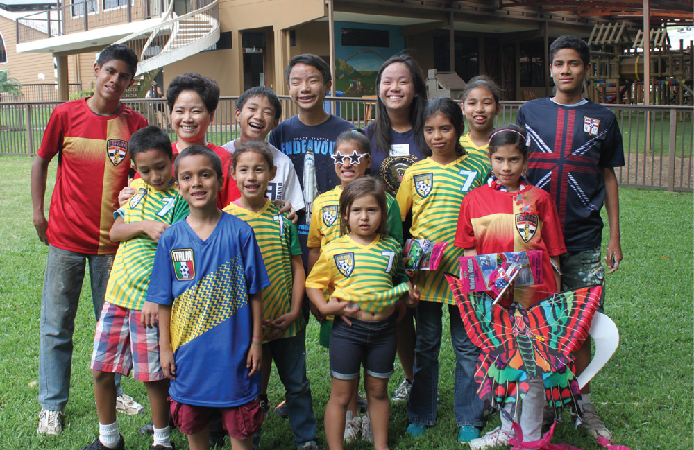 Dr. Emily Letran standing with children